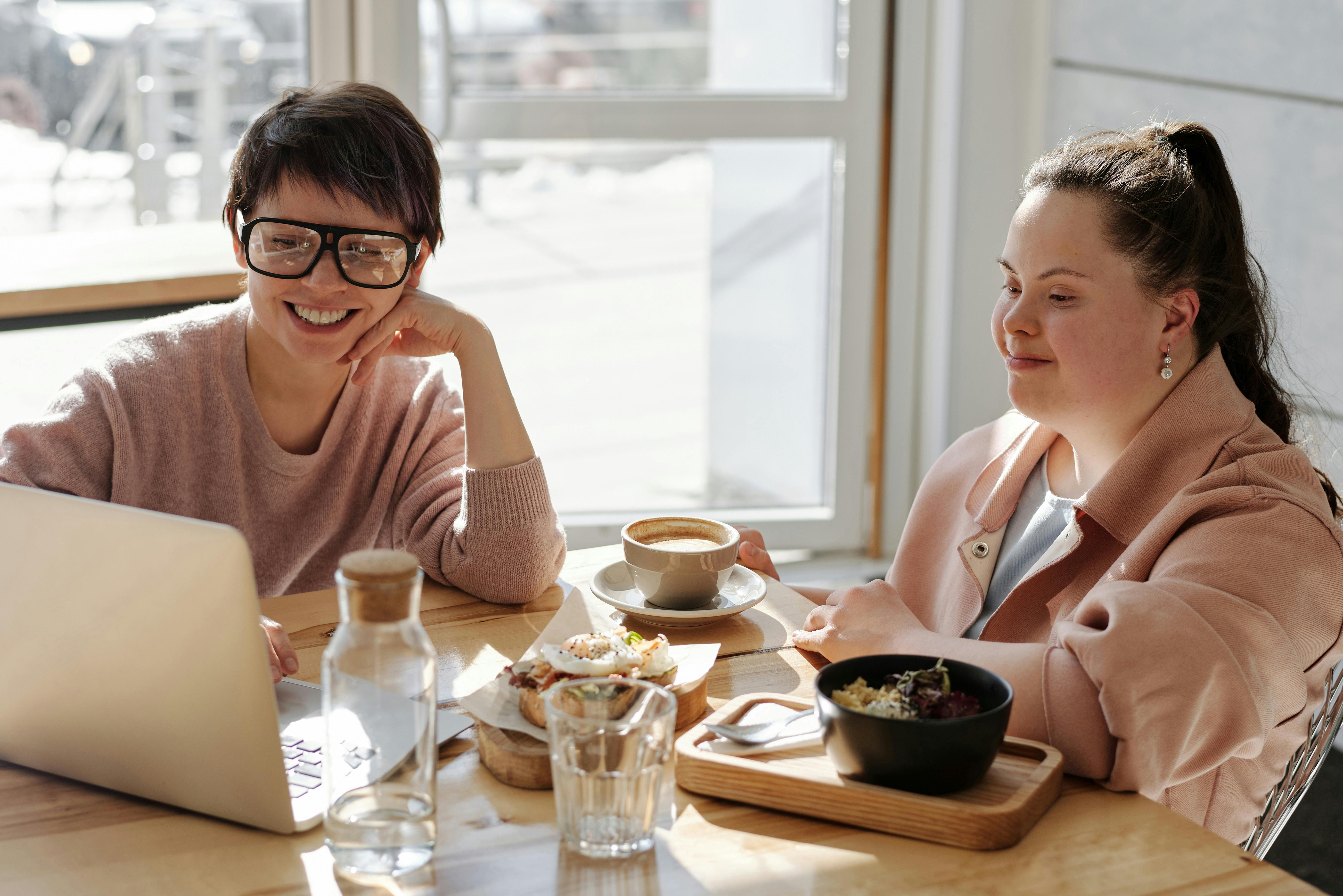 Caregiver assisting a person with disability, smiling together